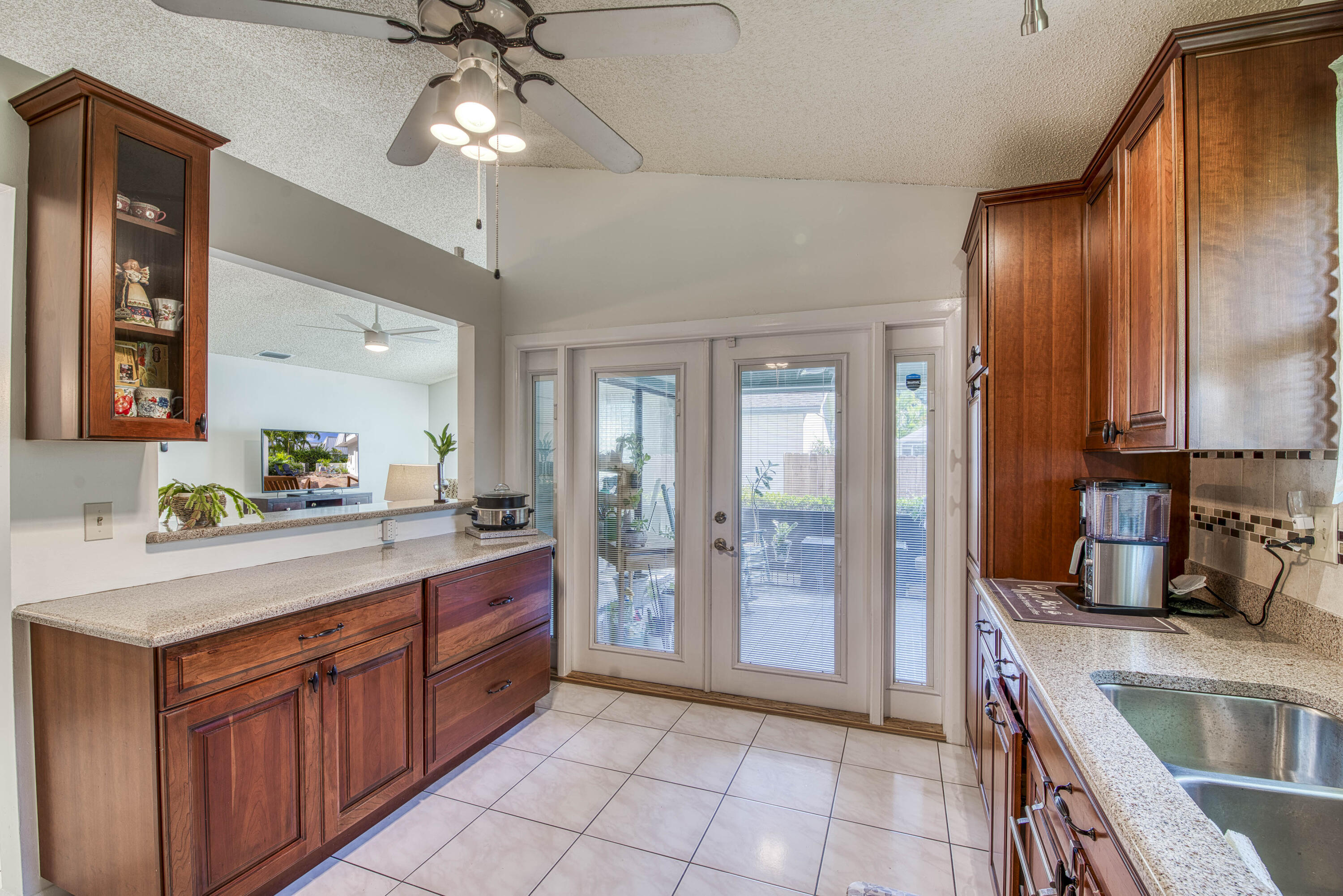 6690 Southeast Raintree Avenue Stuart, FL 34997 - Photo 14 of 43 a large kitchen with stainless steel appliances granite countertop a sink and cabinets