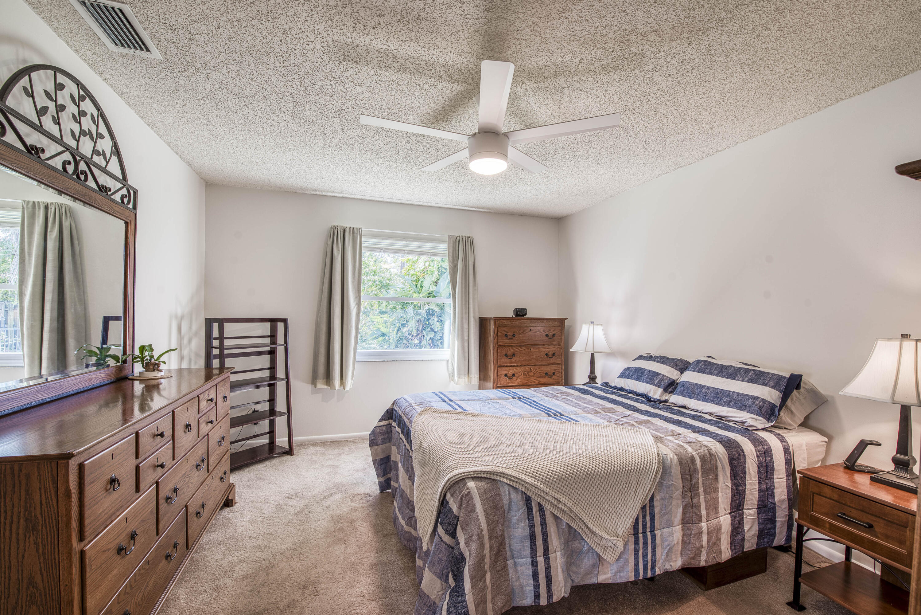 6690 Southeast Raintree Avenue Stuart, FL 34997 - Photo 18 of 43 a bedroom with a bed next to a large window