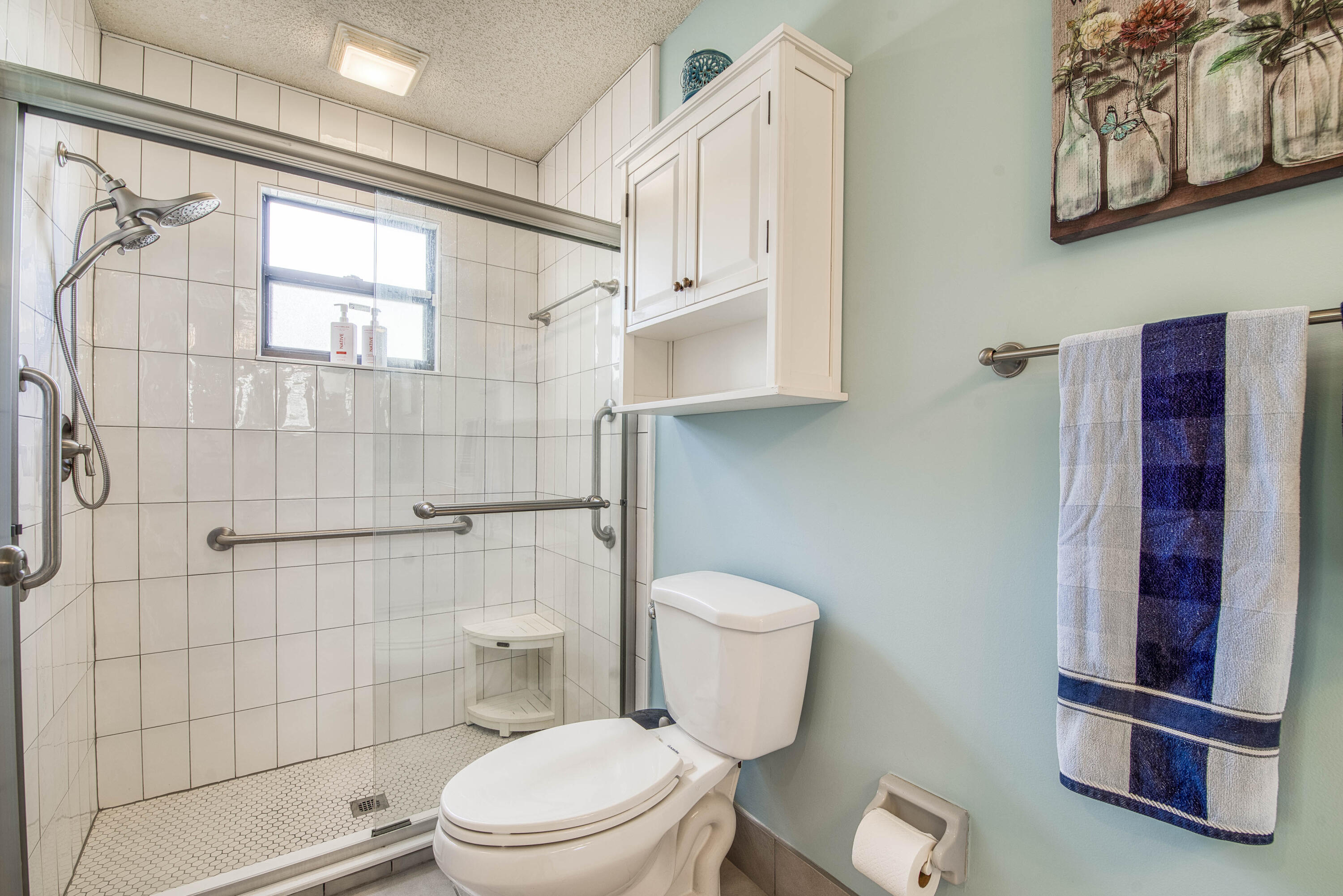 6690 Southeast Raintree Avenue Stuart, FL 34997 - Photo 20 of 43 a white toilet sitting next to a bathroom sink