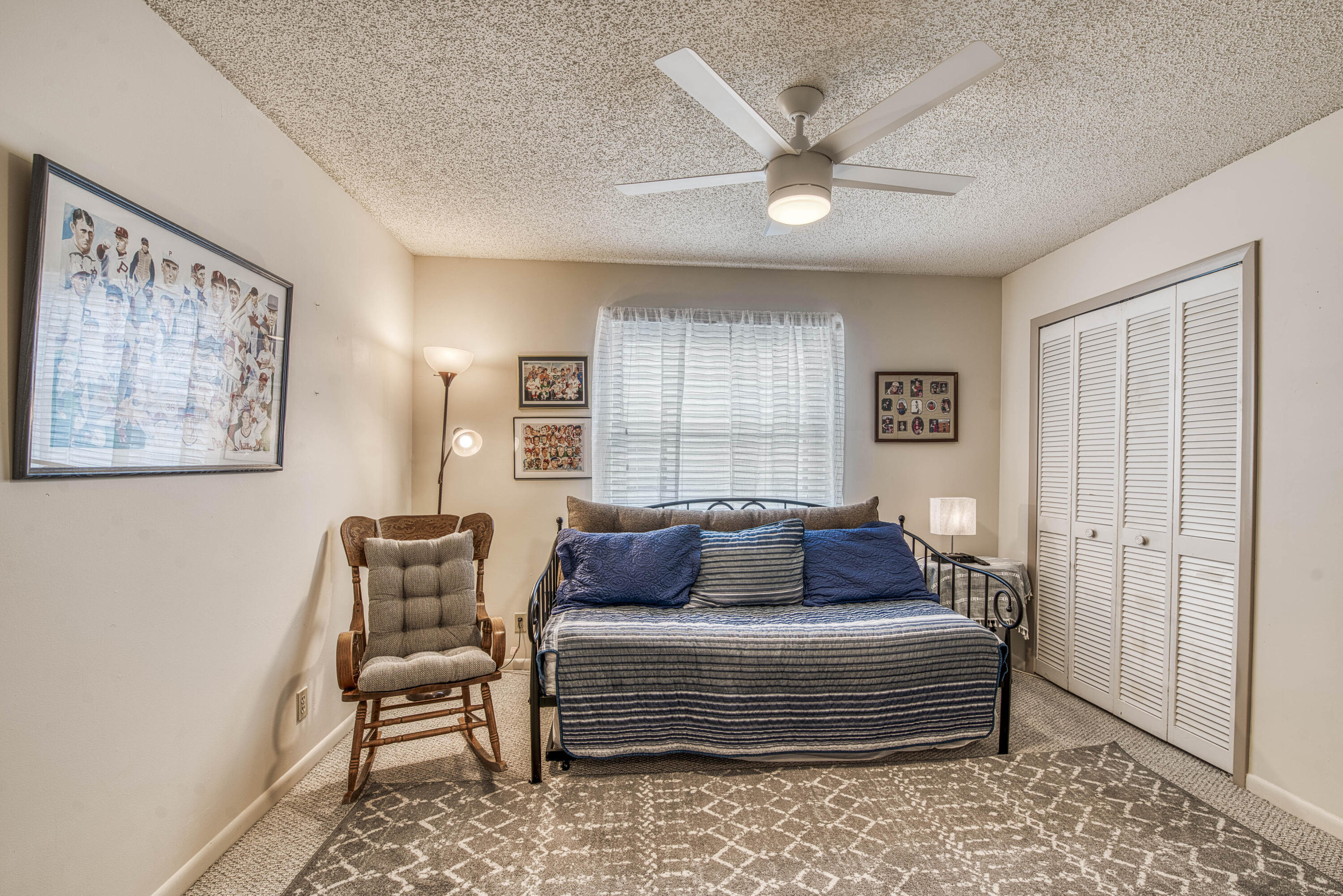 6690 Southeast Raintree Avenue Stuart, FL 34997 - Photo 24 of 43 a bedroom with a bed and window