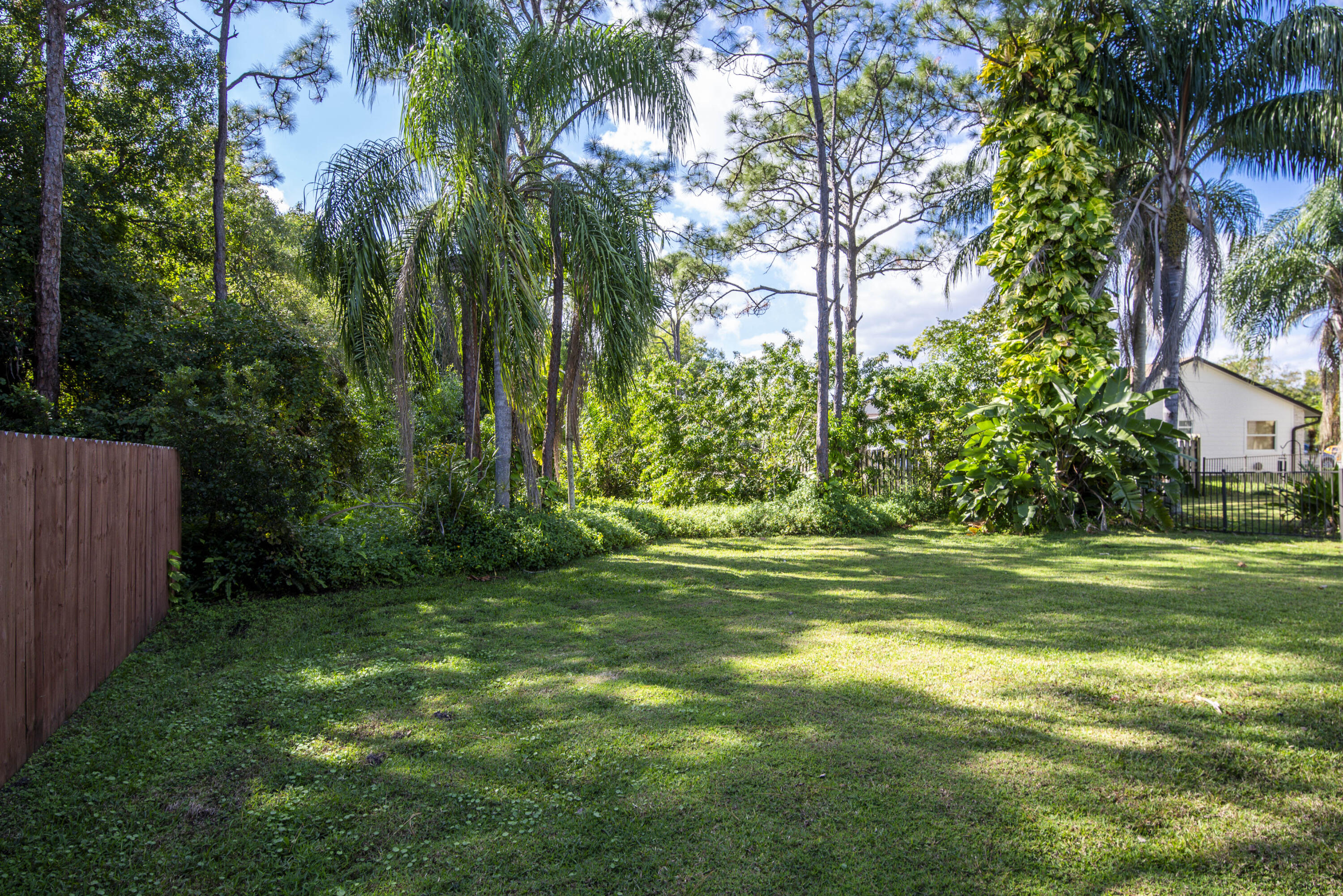 6690 Southeast Raintree Avenue Stuart, FL 34997 - Photo 27 of 43 a view of a grassy field with trees