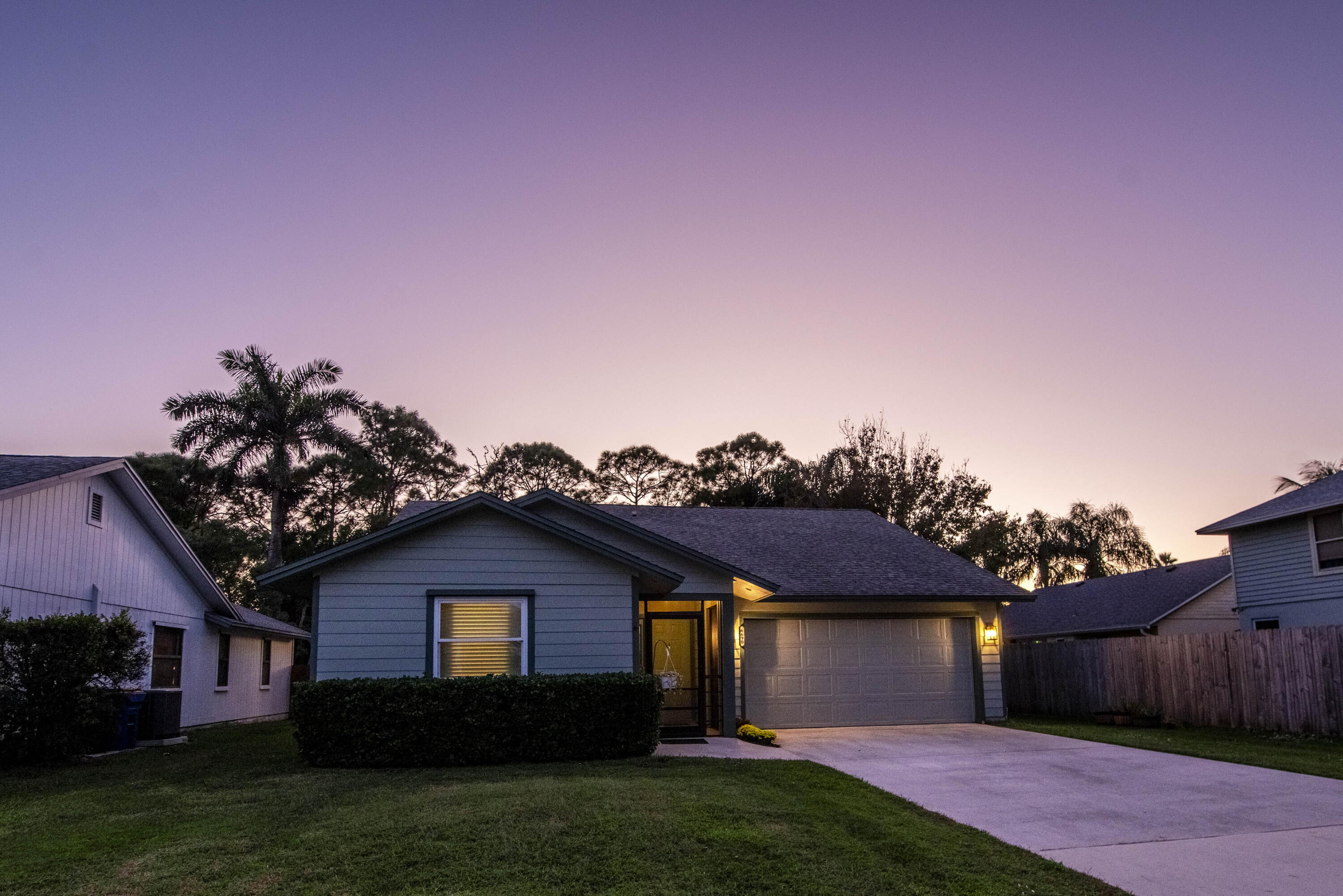 6690 Southeast Raintree Avenue Stuart, FL 34997 - Photo 32 of 43 a front view of a house with a garden and yard