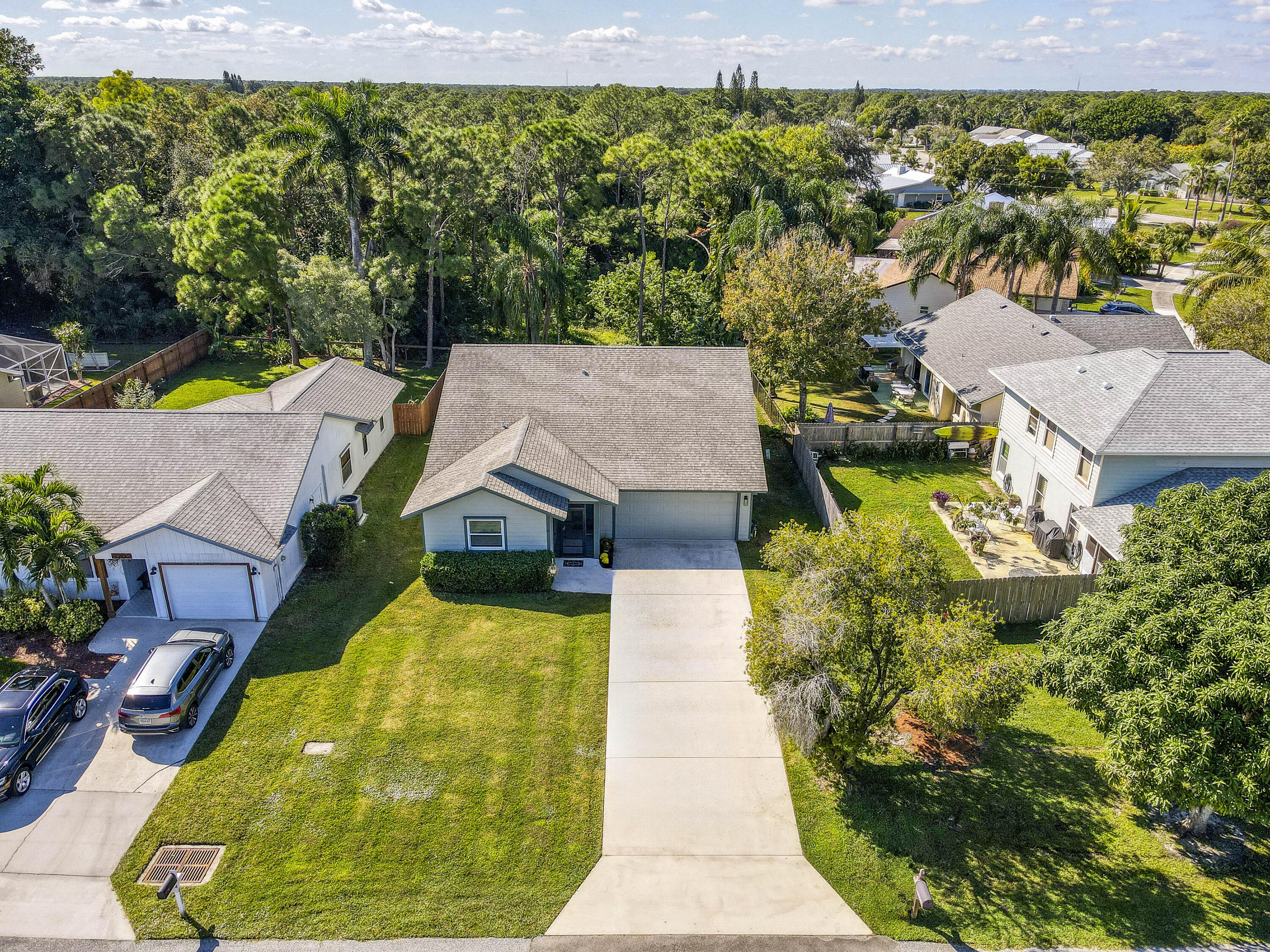 6690 Southeast Raintree Avenue Stuart, FL 34997 - Photo 35 of 43 an aerial view of a house with swimming pool and large trees
