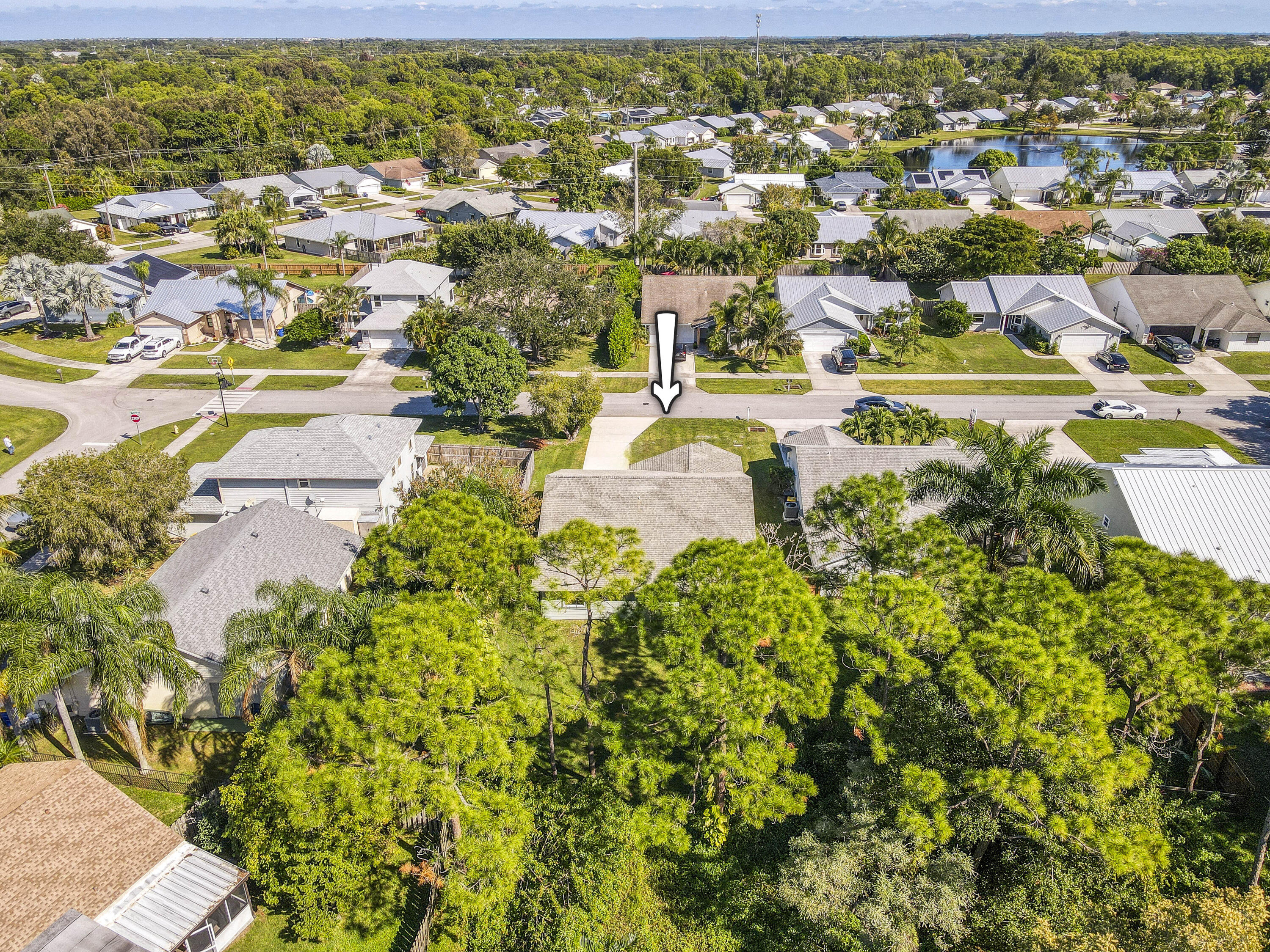6690 Southeast Raintree Avenue Stuart, FL 34997 - Photo 38 of 43 an aerial view of residential houses with outdoor space and trees