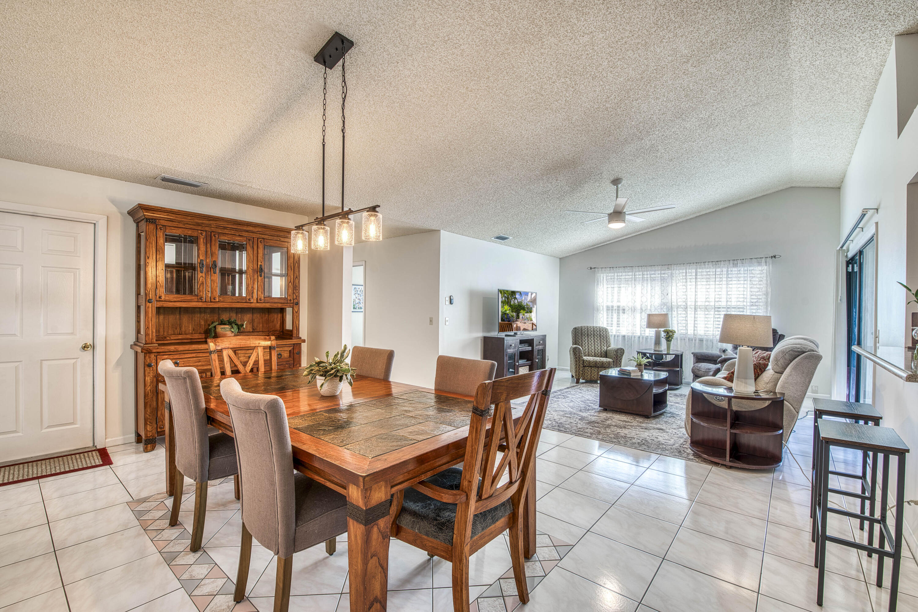 6690 Southeast Raintree Avenue Stuart, FL 34997 - Photo 8 of 43 a dining room with furniture window and wooden floor