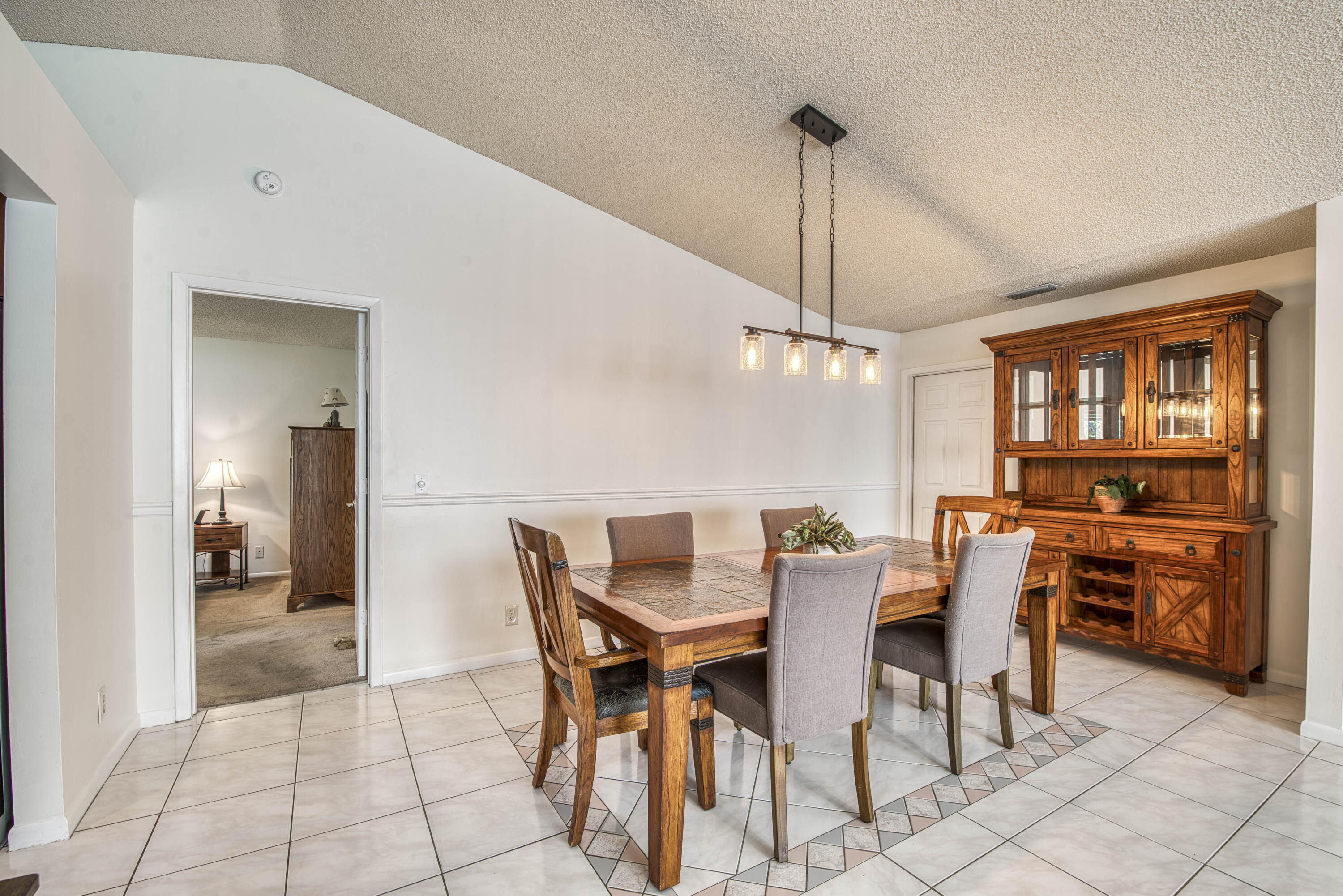 6690 Southeast Raintree Avenue Stuart, FL 34997 - Photo 9 of 43 a view of a dining room with furniture