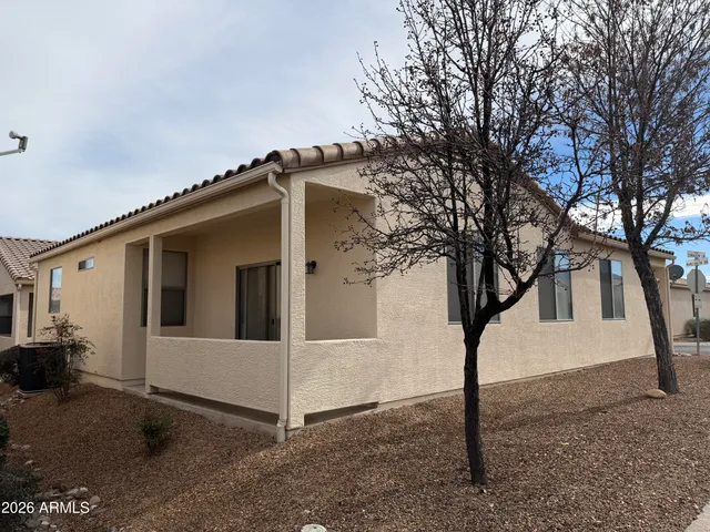a view of white house with a large tree