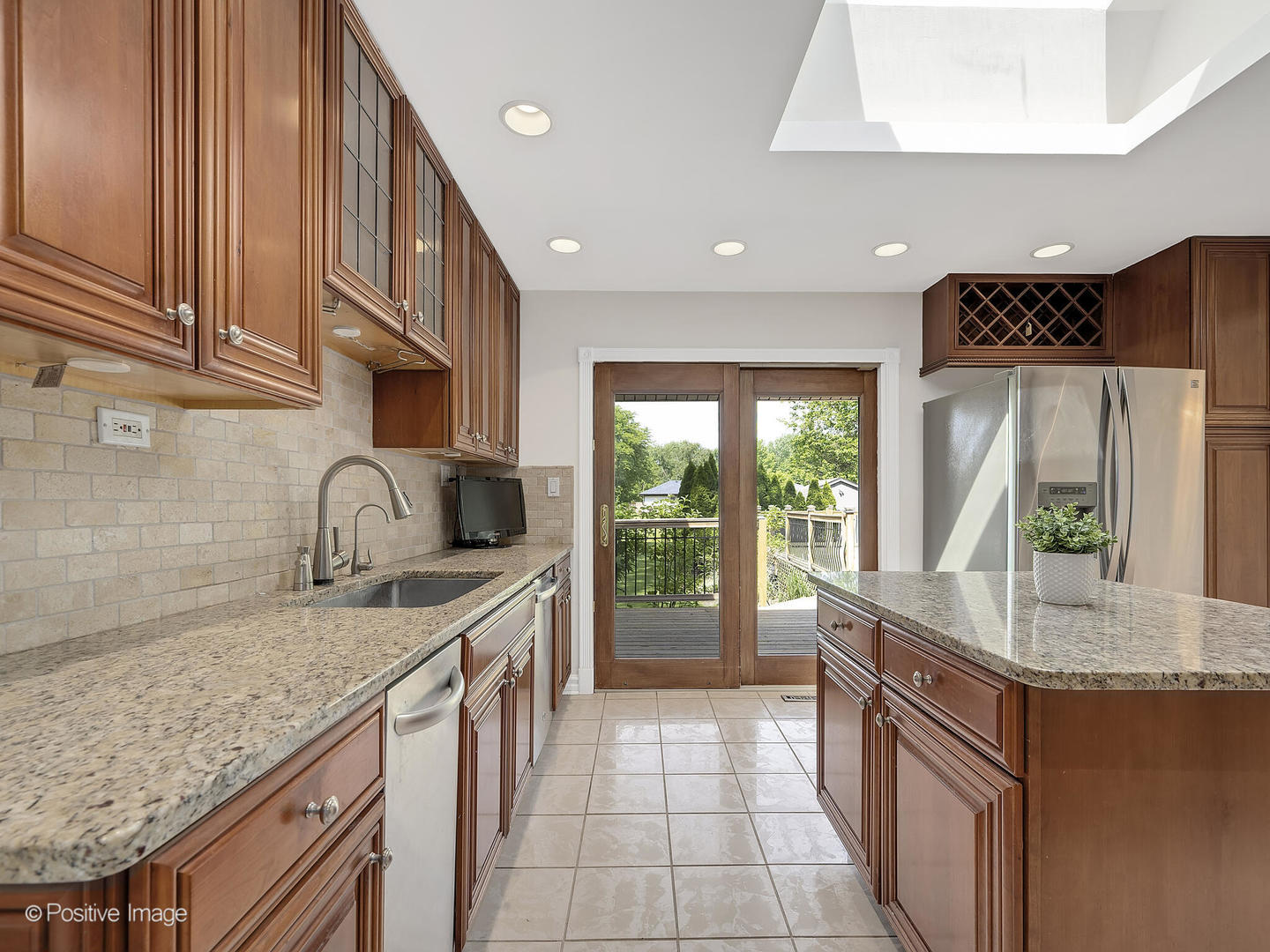 11S568 Book Road Naperville, IL 60564 - Photo 12 of 25 a kitchen with stainless steel appliances granite countertop a sink a stove and a wooden cabinets