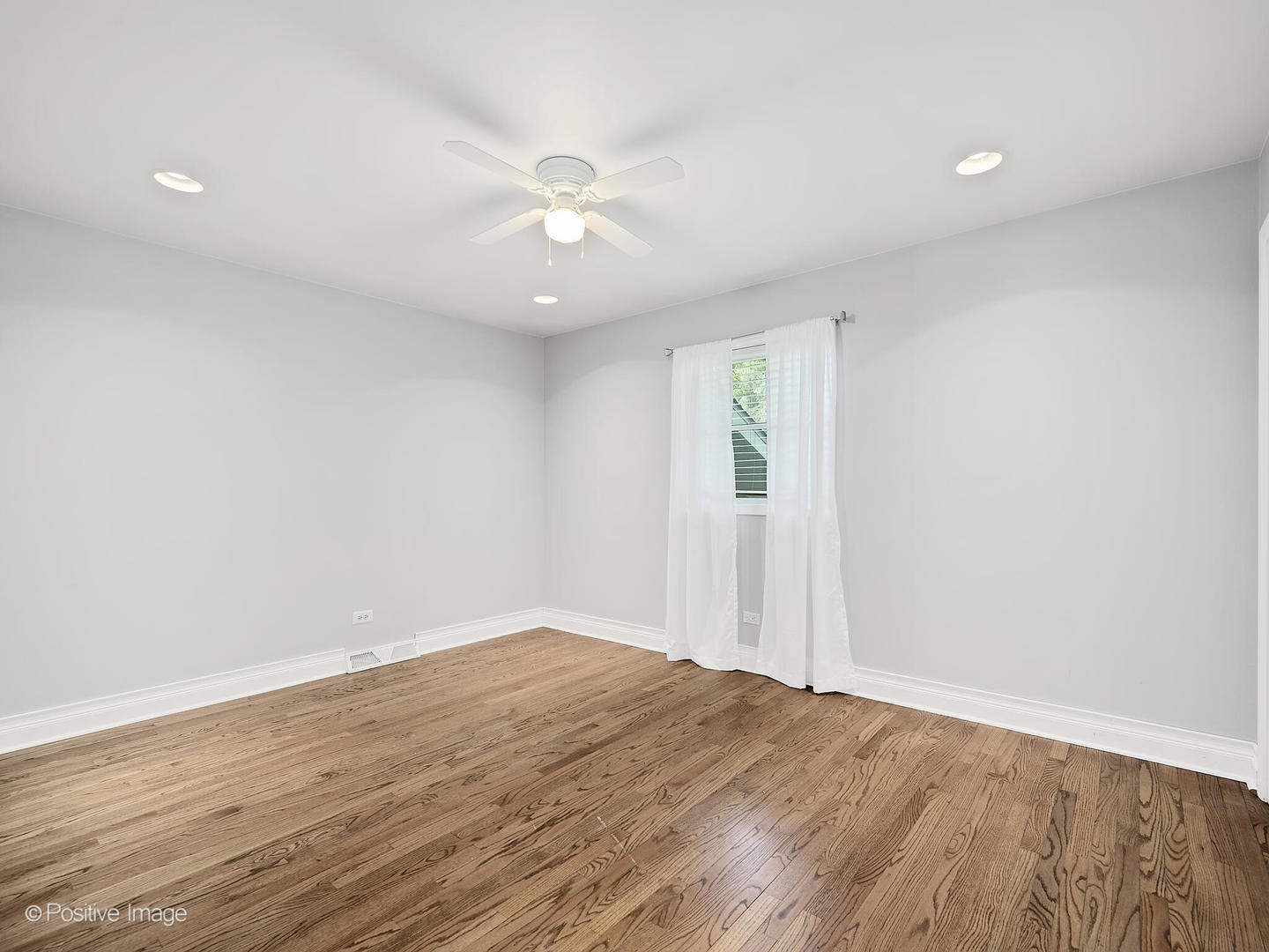 11S568 Book Road Naperville, IL 60564 - Photo 16 of 25 an empty room with wooden floor and fan