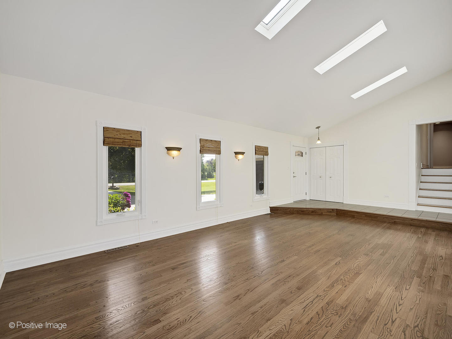 11S568 Book Road Naperville, IL 60564 - Photo 5 of 25 a view of an empty room with wooden floor and a window