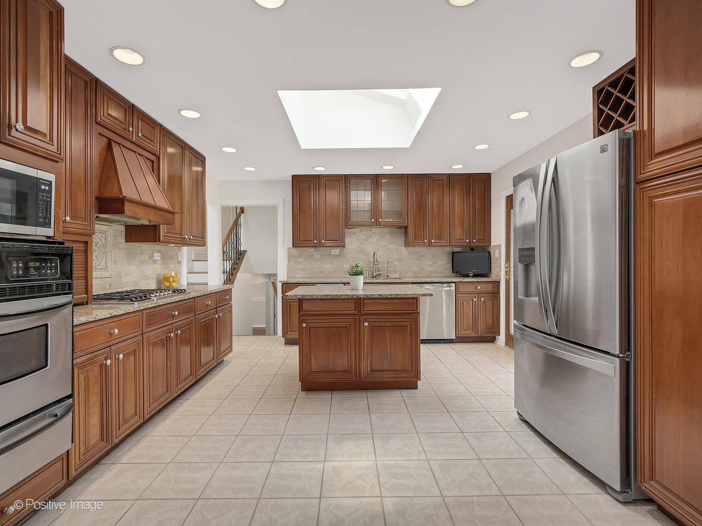11S568 Book Road Naperville, IL 60564 - Photo 10 of 25 a large kitchen with stainless steel appliances granite countertop a stove refrigerator sink and cabinets