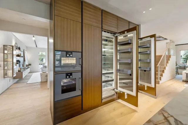 a view of a hallway with wooden floor and windows
