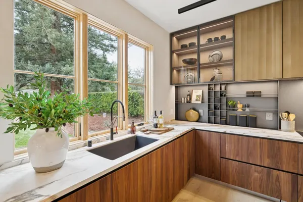 a kitchen with a large window and sink