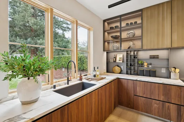 a kitchen with a large window and sink