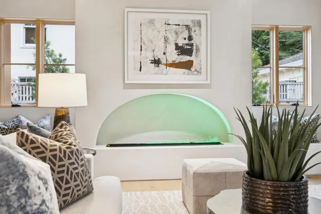 a view of a bedroom with a couch and a potted plant