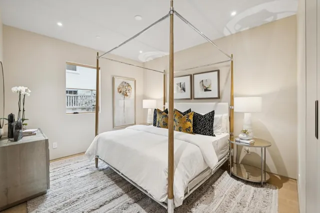 a bedroom with a large bed and a chandelier