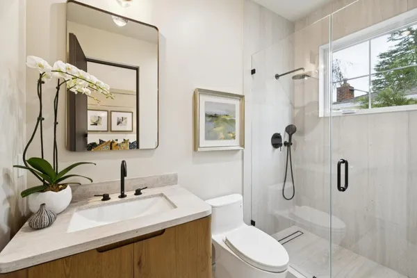 a bathroom with a sink toilet and shower