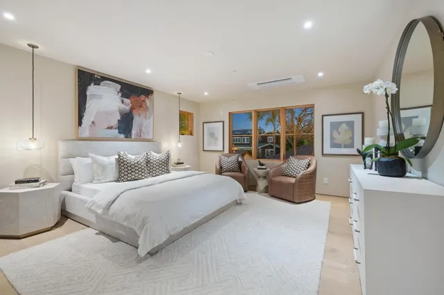 a spacious bedroom with double bed and a large window