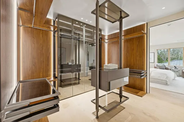 a room with gym equipment and a glass door shower