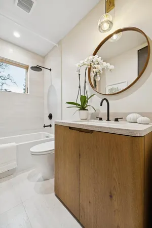 a bathroom with a sink a toilet and a mirror