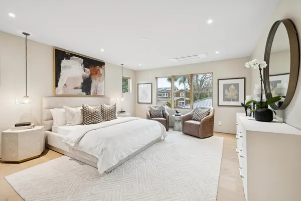 a spacious bedroom with a large bed and a large window