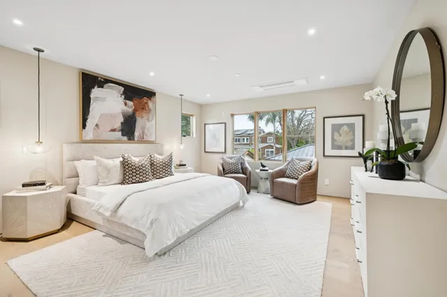 a spacious bedroom with a large bed and a large window