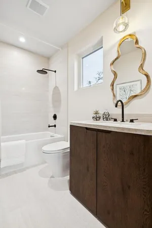 a bathroom with a sink a toilet and bathtub
