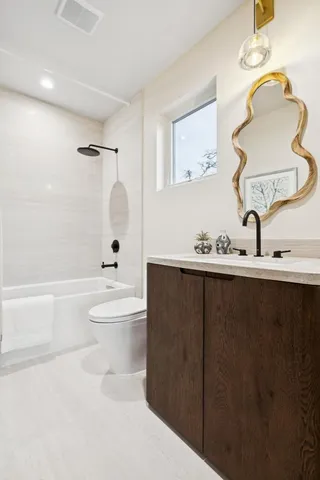 a bathroom with a sink a toilet and bathtub