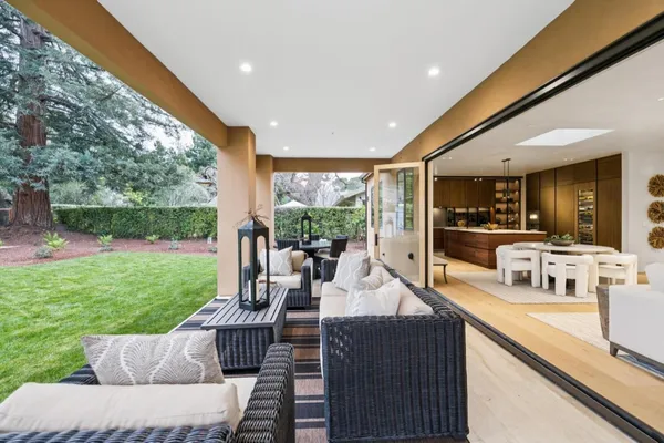 a living room with patio furniture and garden