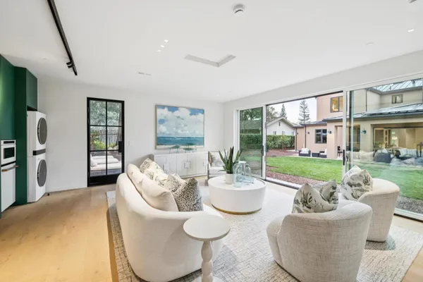 a living room with furniture and a floor to ceiling window