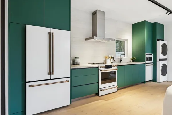 a kitchen with a refrigerator and a sink