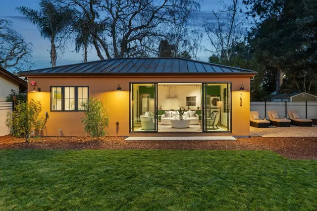 a view of a house with backyard and porch