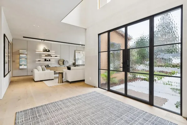 a room with a bed and large window