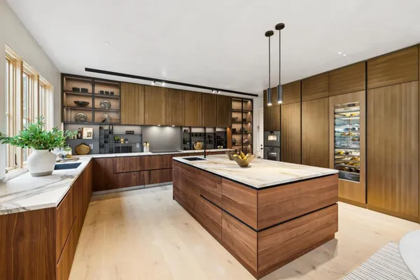 a kitchen with stainless steel appliances kitchen island a sink stove and refrigerator