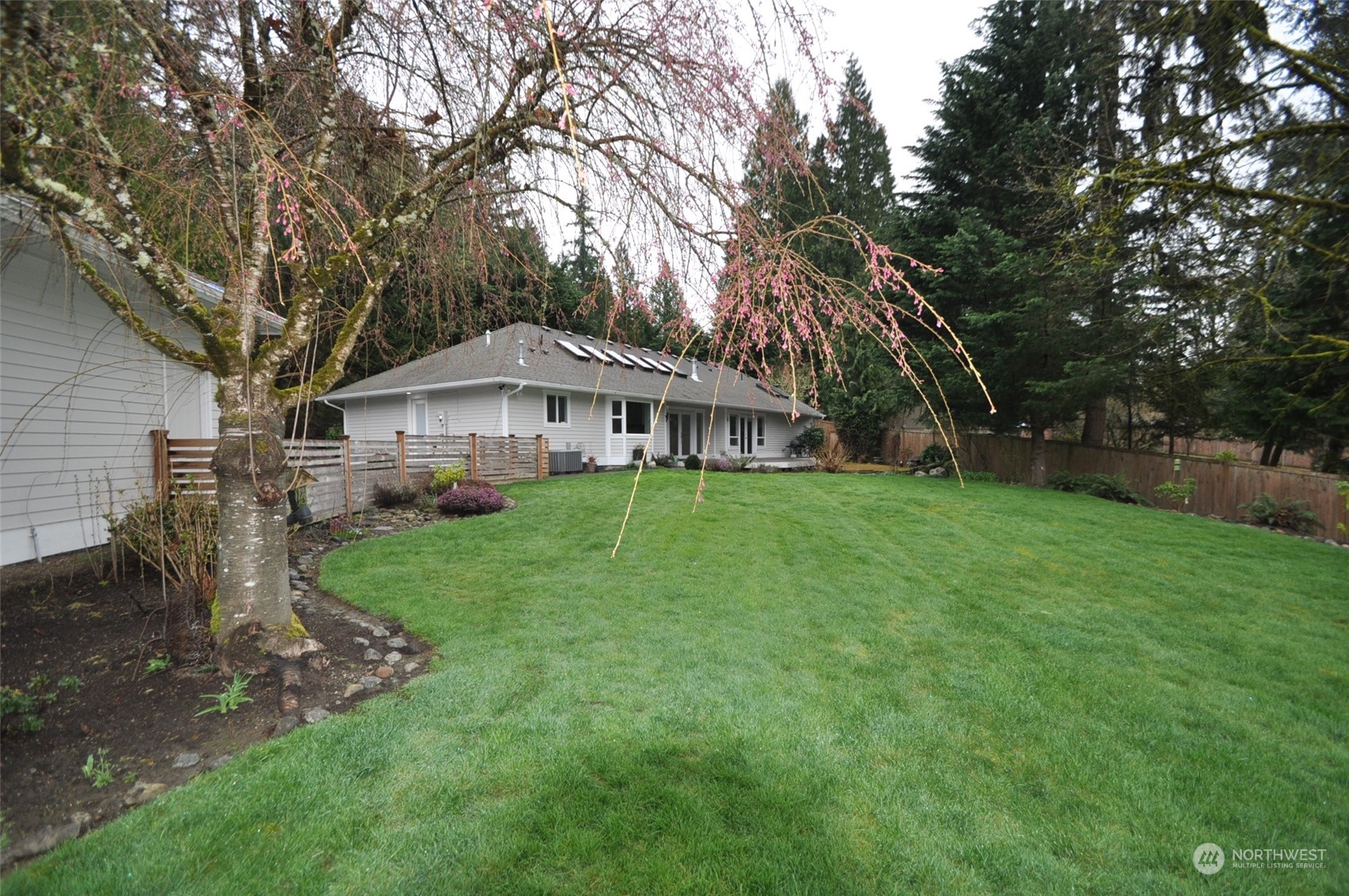 13003 Lake Kathleen Road Southeast Renton, WA 98059 - Photo 11 of 13 a house with green field in front of it