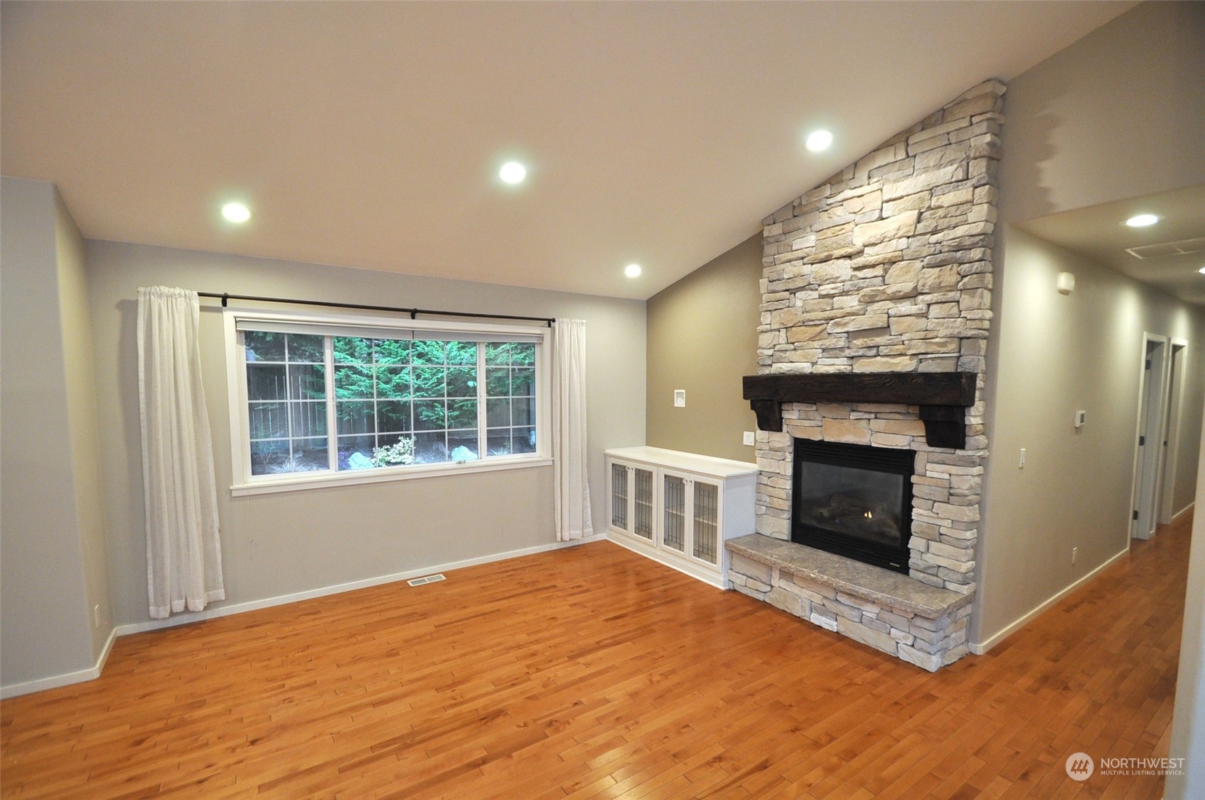 13003 Lake Kathleen Road Southeast Renton, WA 98059 - Photo 6 of 13 a view of an empty room with a fireplace and a window
