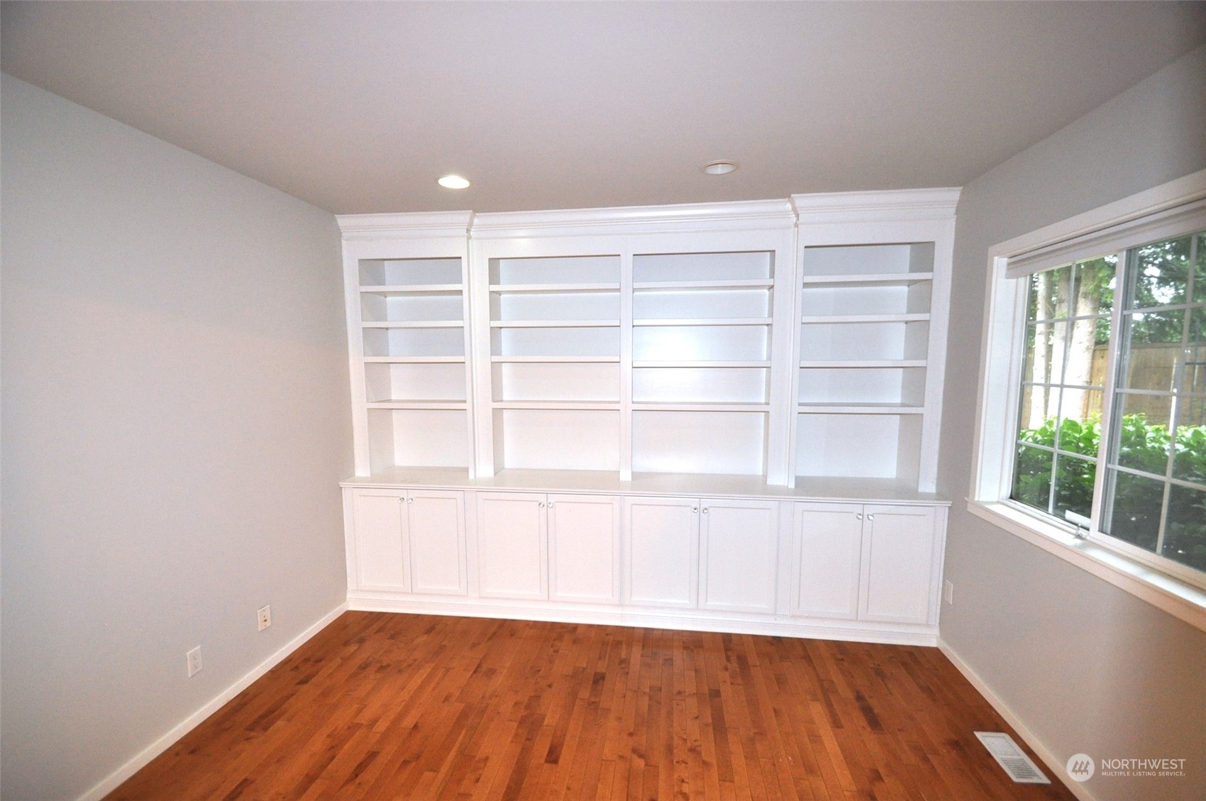 13003 Lake Kathleen Road Southeast Renton, WA 98059 - Photo 9 of 13 a view of a room with wooden floor and a window
