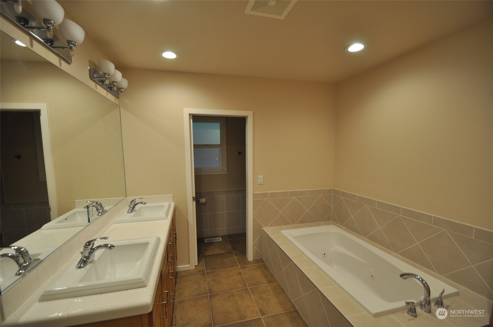 13003 Lake Kathleen Road Southeast Renton, WA 98059 - Photo 10 of 13 a bathroom with a tub sink and mirror