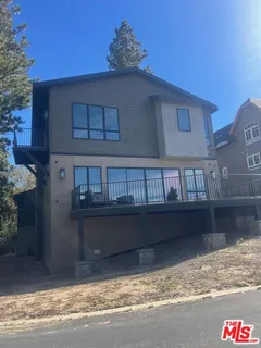 a picture of a room with a white wall and bed