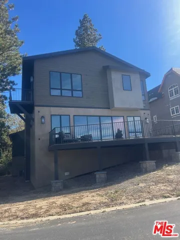 a picture of a room with a white wall and bed