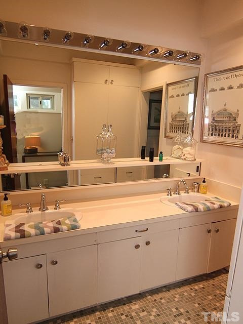 4901 Rembert Drive Raleigh, NC 27612 - Photo 17 of 25 Hall bathroom is very modern with tons of storage, tile flooring, toilet and a tub/shower combo. Hall Bath