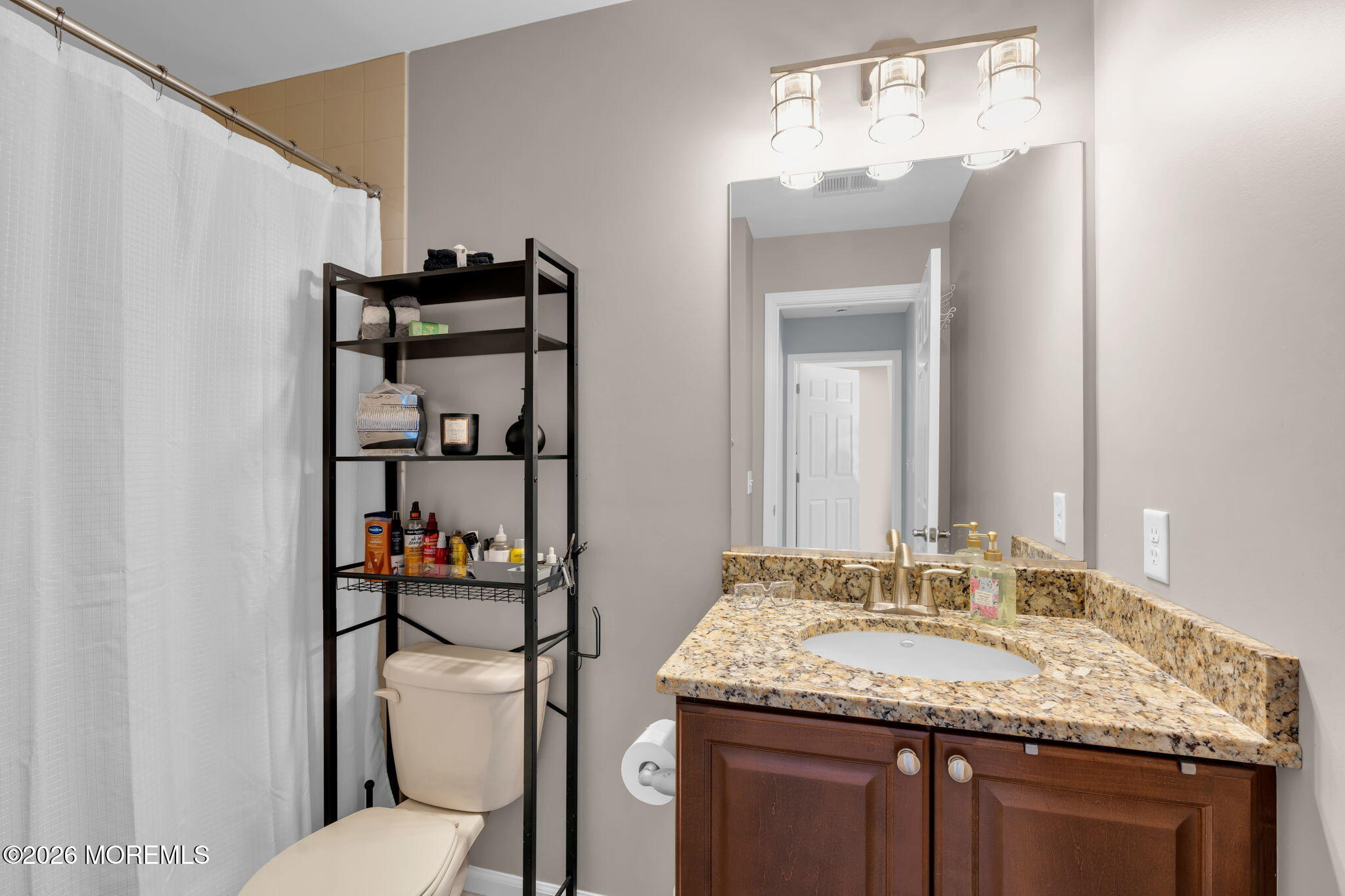 62 Santa Rosa Lane Tinton Falls, NJ 07753 - Photo 18 of 23 a bathroom with a granite countertop sink a toilet and a mirror