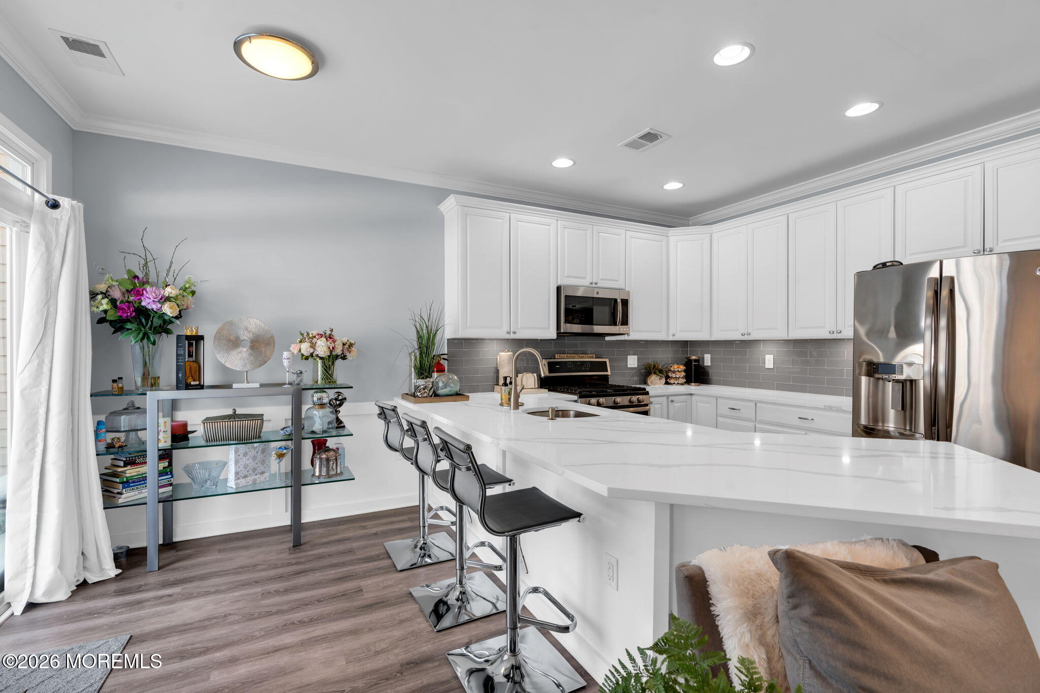 62 Santa Rosa Lane Tinton Falls, NJ 07753 - Photo 9 of 23 a kitchen with stainless steel appliances granite countertop a refrigerator a stove top oven a sink dishwasher and white cabinets with wooden floor