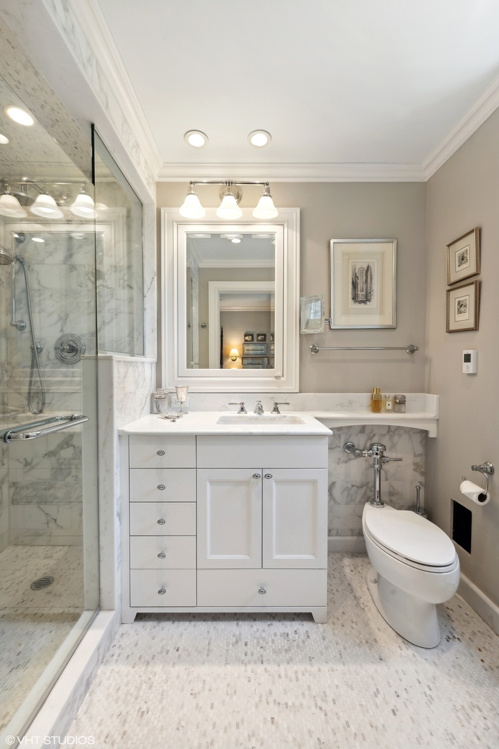 20 East Cedar Street, Unit 6E Chicago, IL 60611 - Photo 24 of 35 a bathroom with a double vanity sink mirror and toilet