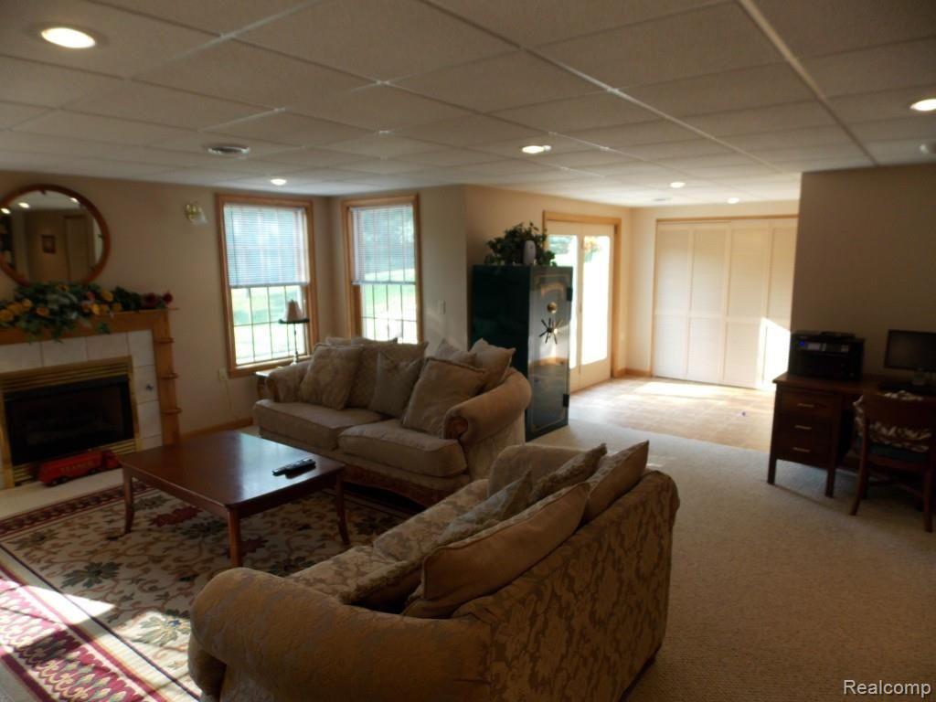 2974 Hannan Road Imlay City, MI 48444 - Photo 31 of 45 The finished basement is a walk-out, with stairs leading from the patio to the deck on the main level.