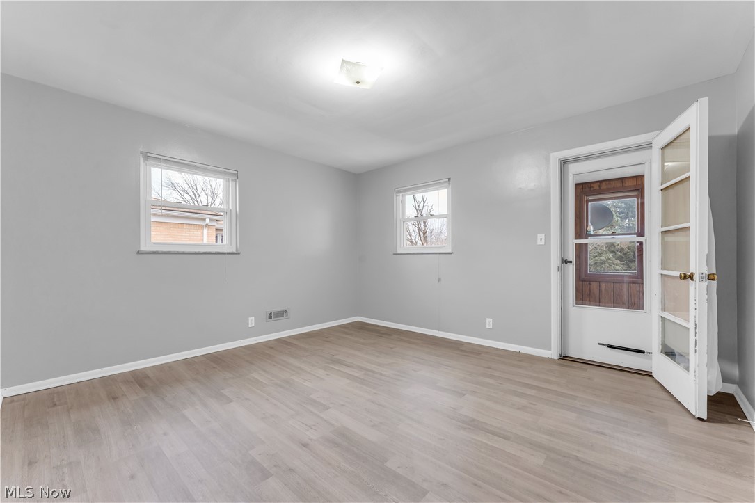 2915 Snow Road, Unit 2/UP Cleveland, OH 44134 - Photo 2 of 23 Spacious room featuring light gray walls, light wood-finish flooring, and white trim