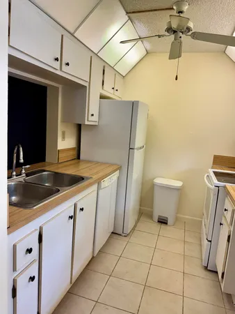 a kitchen with a sink and refrigerator