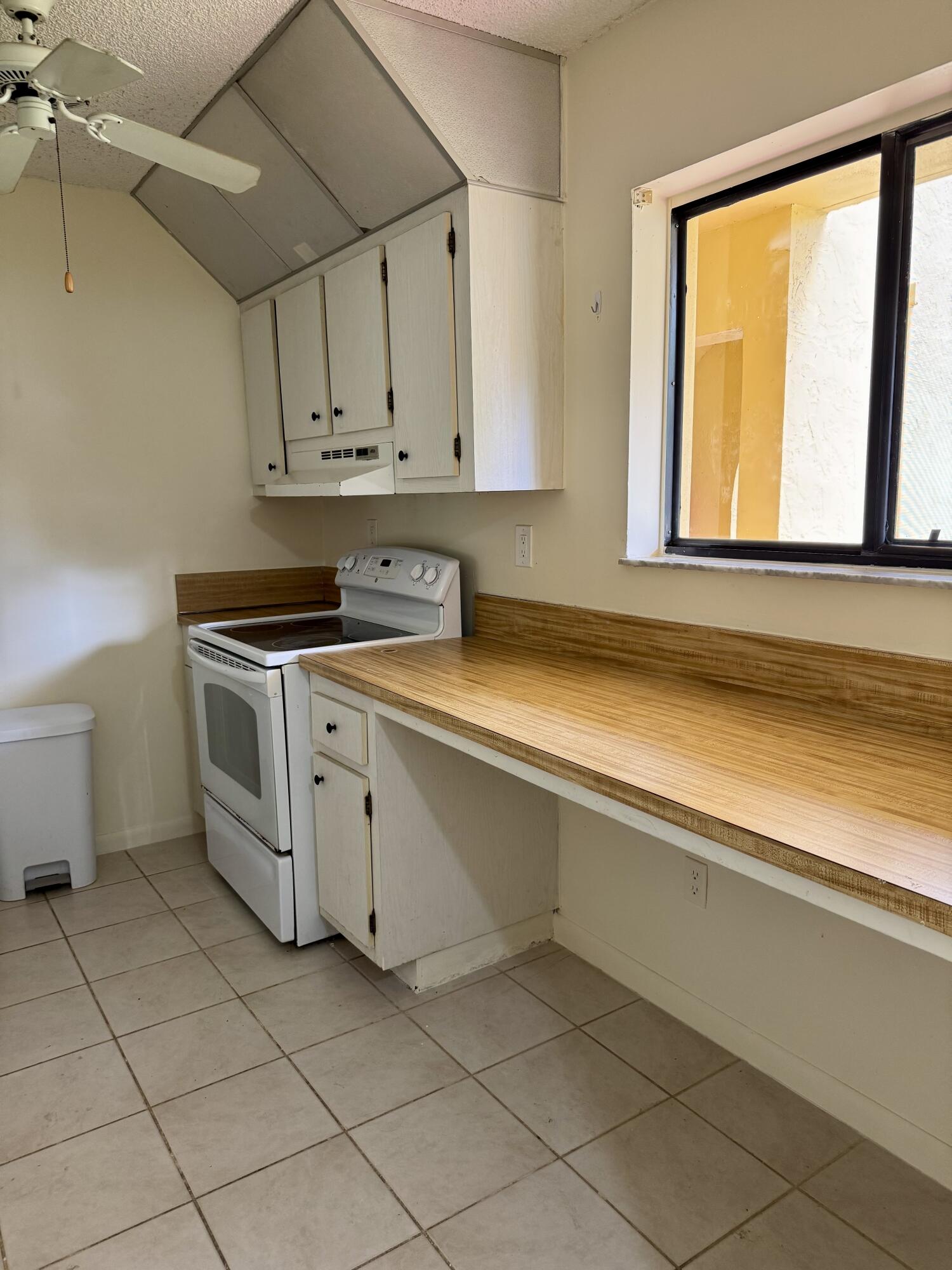 912 Southwest 9th St Circle, Unit 101 Boca Raton, FL 33486 - Photo 14 of 25 a kitchen with a stove and a sink