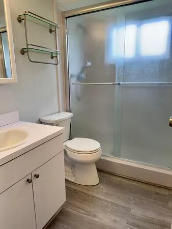 a bathroom with a toilet a sink and shower
