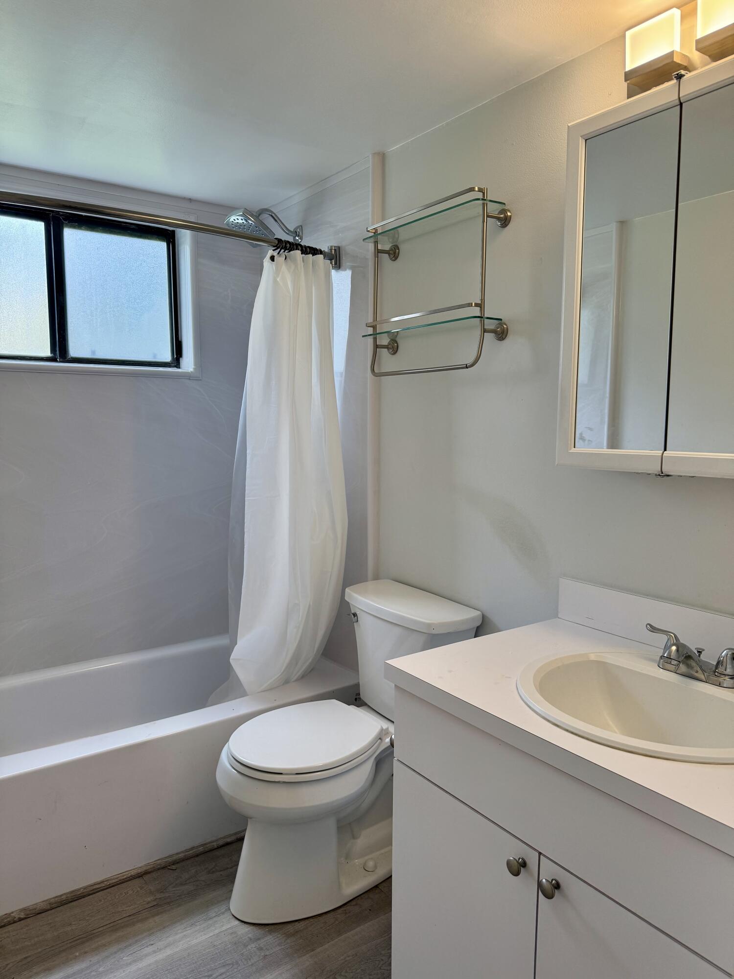 912 Southwest 9th St Circle, Unit 101 Boca Raton, FL 33486 - Photo 18 of 25 a bathroom with a sink toilet and shower